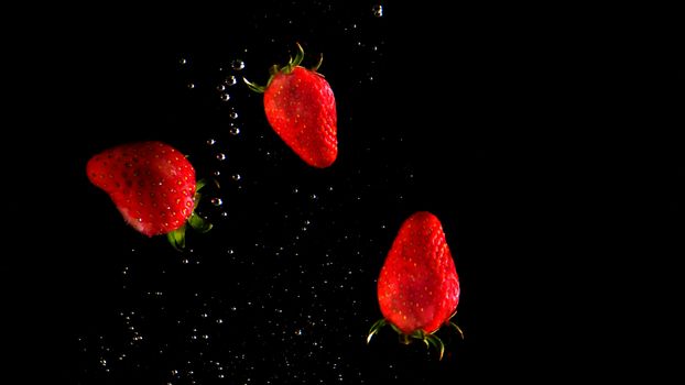 Colorful fresh vegetable cleaning by drop in to water splash and black background.