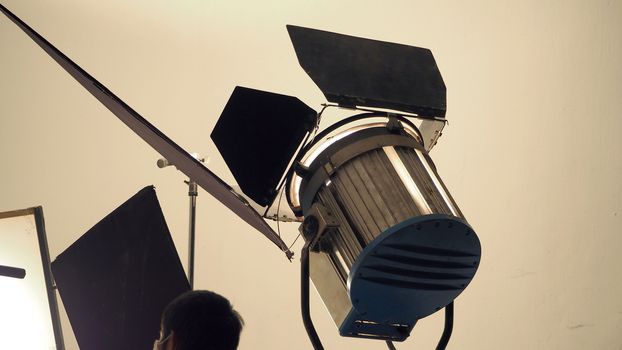 Big LED studio spotlight and tripod for professional video or movie commercial shooting.