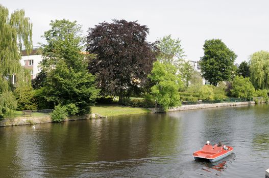 Two persons in a paddleboat, Alster, Hamburg, Germany.