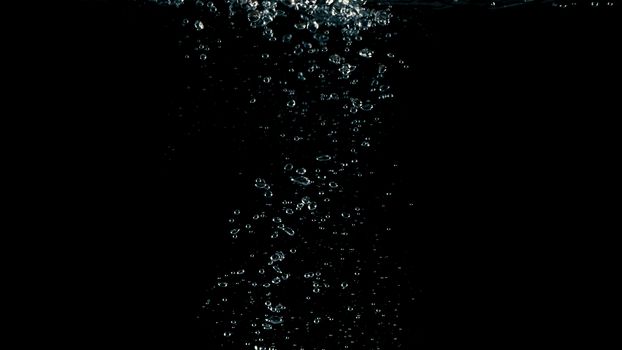 Soda water liquid splashing bubbles drop in black background represent sparkling and refreshing