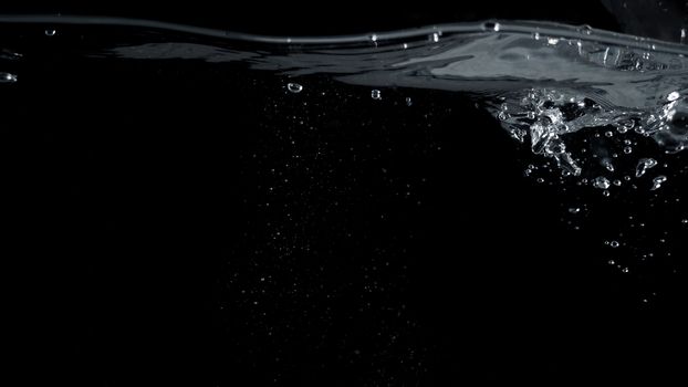 Soda water liquid splashing bubbles drop in black background represent sparkling and refreshing