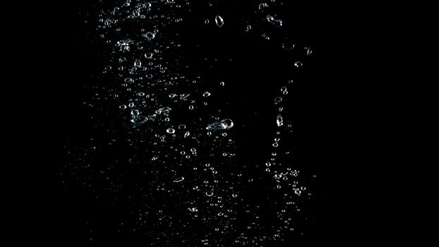 Soda water liquid splashing bubbles drop in black background represent sparkling and refreshing