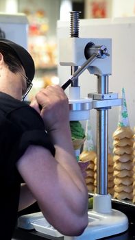 White creamy soft serve ice cream cone made by dairy milk cooling frozen machine for sweet tasty snack.