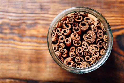 Cinnamon Sticks in Jar on Wooden Table. View from Above and Copy Space.