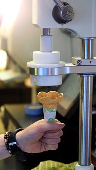 White creamy soft serve ice cream cone made by dairy milk cooling frozen machine for sweet tasty snack.
