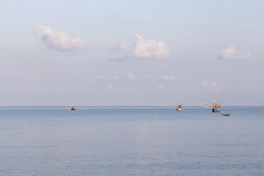 Sea with fishing boats and blue sky