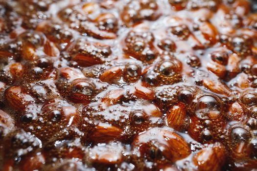 roasted almonds with cinnamon sugar cooking process, top view close-up