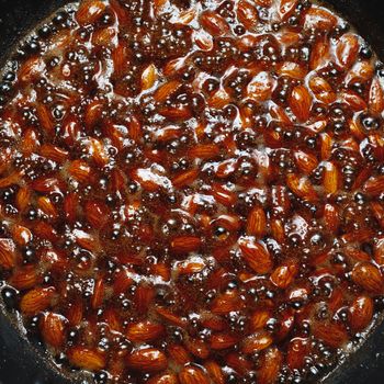 roasted almonds with cinnamon sugar cooking process, top view close-up