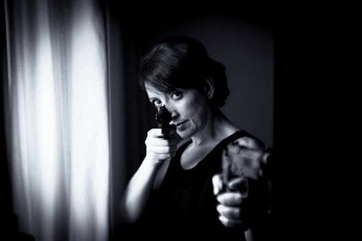Portrait of woman with gun. Black dress