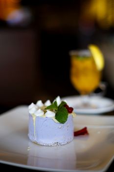 Round cake dessert. Cheesecake on a plate in a cafe.