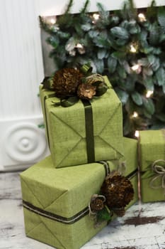 Boxes with Christmas gifts wrapped in wrapping paper near the Christmas tree. Christmas holiday atmosphere