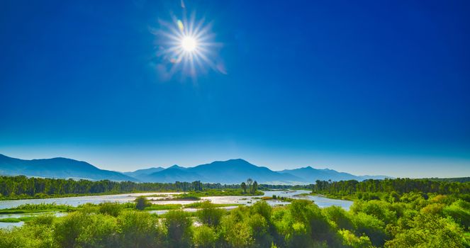 Snake River with blue skies and  the morning sun.