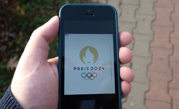 October 22, 2019.  Paris, France. Logo of the XXXIII  Summer Olympics games 2024 on a mobile phone screen.