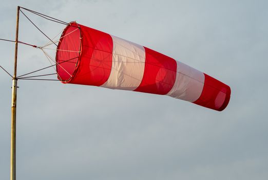 red-and-white wind designator designed to indicate the direction and approximate speed of the wind on the seashore