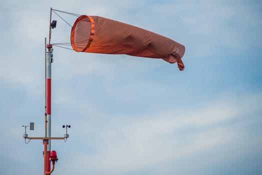 red-and-white wind designator designed to indicate the direction and approximate speed of the wind on the seashore