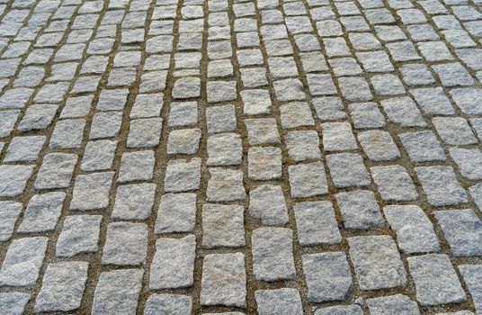 Old cobblestone pavement in the ancient European city