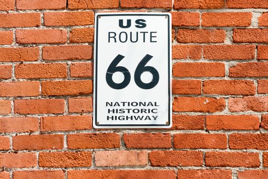 US Route 66 National Historic Highway sign on red brick wall, Galena, Kansas, USA