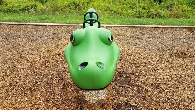 wet green playground equipment or play structure ride at park