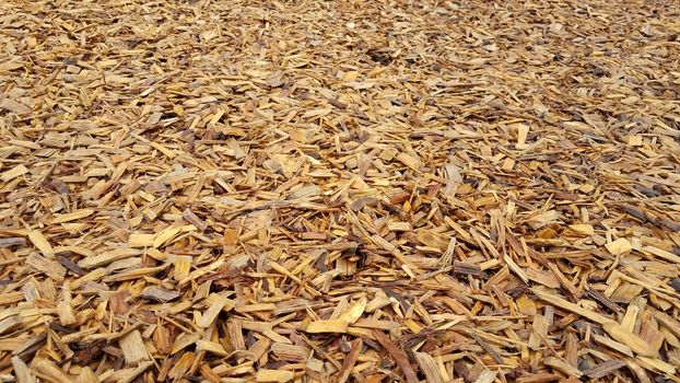 wet brown mulch or wood chips or bark dust on ground or background