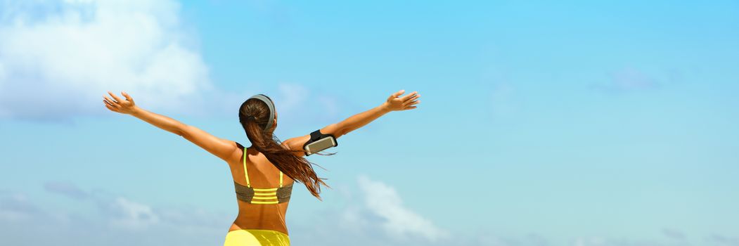 Fitness healthy lifestyle running woman banner panorama. Freedom happiness sporty girl with open arms in success on blue sky copy space.