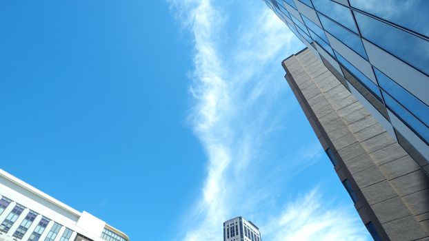 Low angle view images of office hotel and department store modern style building in Sapporo Hokkaido Japan on summer season day with blue clear sky and white cloud.