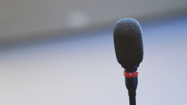 Mini microphone speaker in conference hall for speech in business seminar or organisation training or study and lecture and blurry images background.