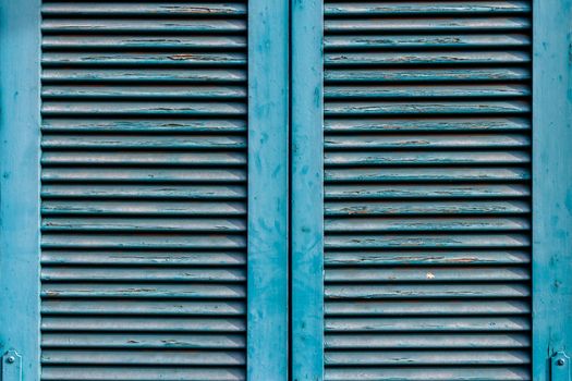 Front view of an old window closed, blue.