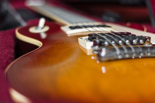 Extreme close-up of an electric guitar in its carry case.