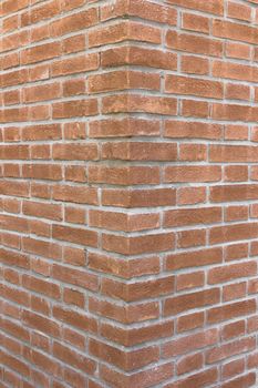 Front view of a wall with bricks arranged in a regular mode.