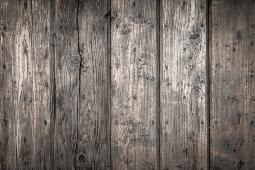 Rough wooden planks, dark and deteriorated by time.
