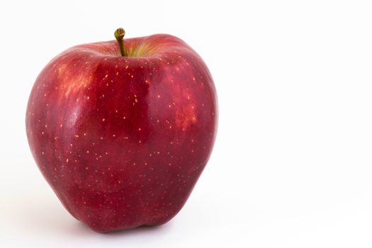 Close-up of a red apple on white background and copy space.