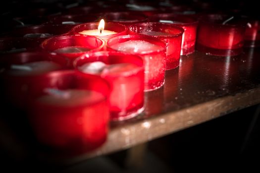 Group of red candles in a church.