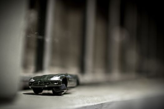 An old toy car abandoned on the street.