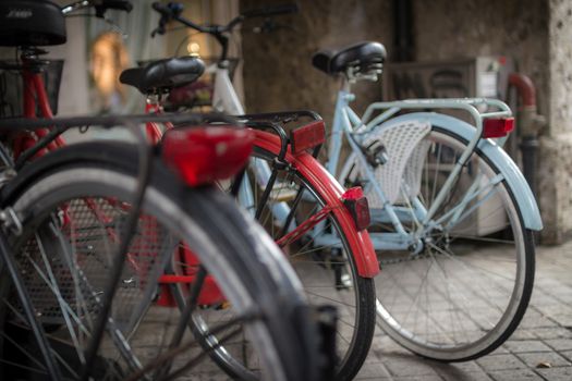 Some colorful bicycles contrast the gray of the city.