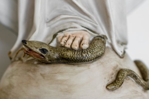 The Virgin Mary crushing the devil.