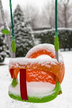 Swing covered by frozen in a winter day.