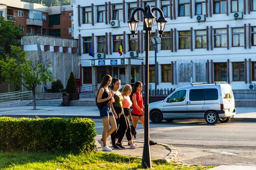 Group of teenagers walking on a street in Orsova, Romania, 2020