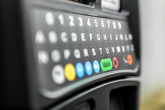A parking meter with digital keyboard.