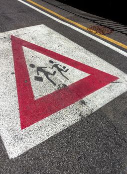 Sign school on the road. Schoolchildren crossing street sign.