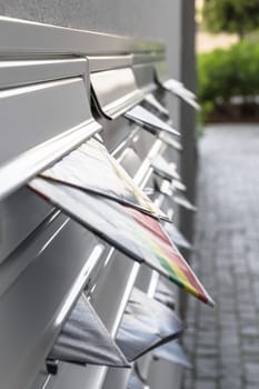 Modern mailboxes filled of leaflets. Business and advertising concepts. Shallow depth of field.