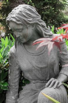 Statue of a mourning woman on a graveyard