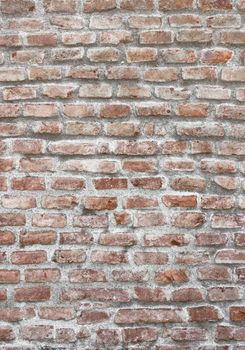 Fragment of a brick wall of an ancient structure. Exterior decoration of the building. A background for design and creative work.