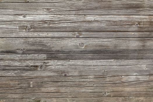 Rough wooden wall with knots and horizontal panels. It can be used as texture and backgrounds.