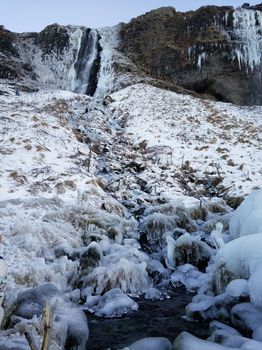 Mountains frozen with ice in winter. Earth, stones are covered with ice.