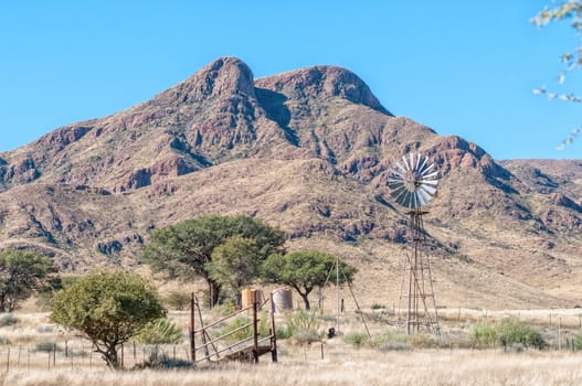Landscape, with windmill and water tanks, at Toekoms in Namib Rand