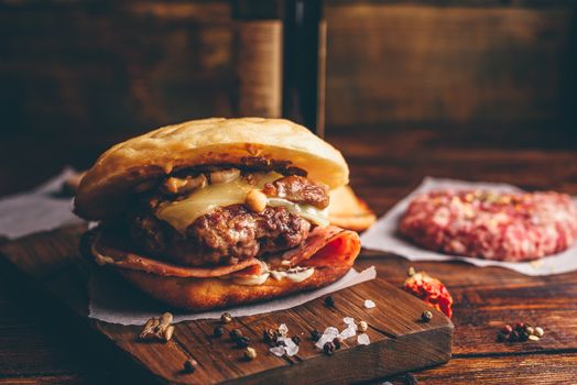 Cheeseburger on Cutting Board with Bottle of Beer