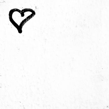 Concept or conceptual painted black abstract heart shape love symbol, dirty wall background, metaphor to urban and romantic valentine, grungy style.