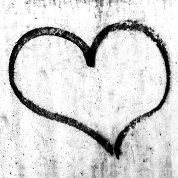 Heart painted on grunge cement wall background, love concept.