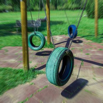 Tire swing in park, background.