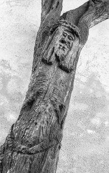 Wood carved statue of crucified Jesus Christ. Strange artistic statue.